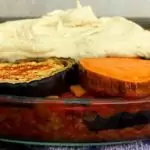 Glazen ovenschaal gevuld met vegan moussaka met seitan